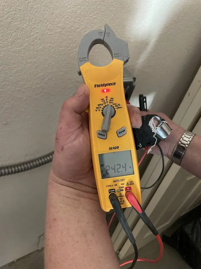 Voltage testing with clamp meter during Electrical Installation Services in Gilford